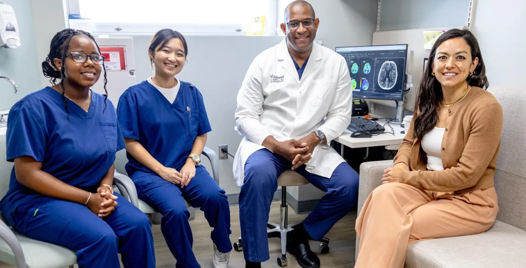 Clinical Neurosurgery Participants pose for a photo with Dr. Vernard S. Fennell and Jacqueline Mills 