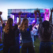 Attendees dance as they watch an act on the main stage during the Soka Peace Festival