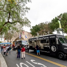 Guests wait in line to order from a food truck during the Soka Peace Festival