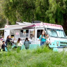 Guests wait in line to order from a food truck during the Soka Peace Festival