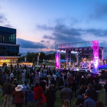 A large crowd watches Ozomatli perform during sunset at the Soka Peace Festival