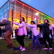 Attendees are in a conga line outside the Performing Arts Center during the Soka Peace Festival