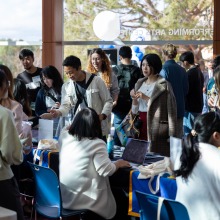 Alumni members and their families check in during the 2024 Alumni Meeting