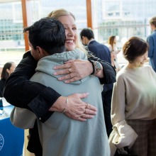 Executive Director of Philanthropy Linda Kennedy hugs a student at the 2024 Alumni Meeting