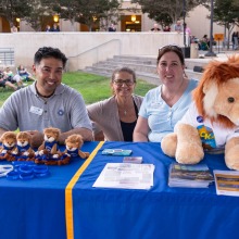 Leo Sasaki, Barbara McGrath, and Carin Rodgers-Bronstein sit at the information table during Summer at Soka