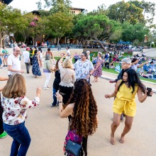 Concertgoers dance during CaliSamba's performance at Summer at Soka