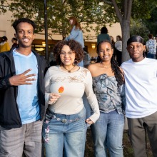 Four students pose for a photo during Two SUA students hold up the bonding bracelets they made during An SUA student gets her meal from the In-N-Out employee during SUA's annual Welcome Back Community Event 