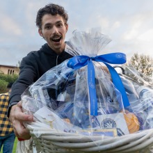 A male student shows off the gift basket he won during SUA's welcome back event