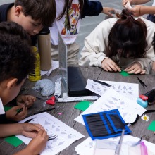 SUA students work intently on their origami contest