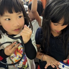 A little girl holds a stethoscope to her heart during a youth health advocacy event at SUA