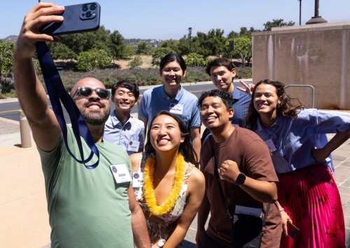 Graduate School Alumni pose for a selfie on campus during the 2024 Reunion.