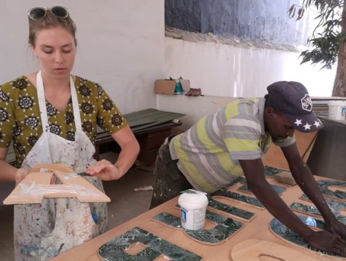 Student and employee working on signage