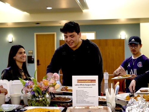 Students serve themselves food during an Affinity Hangout