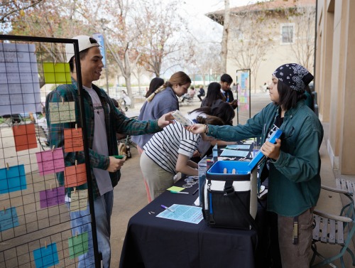 SUA students interact during a tabling event on SUA's campus