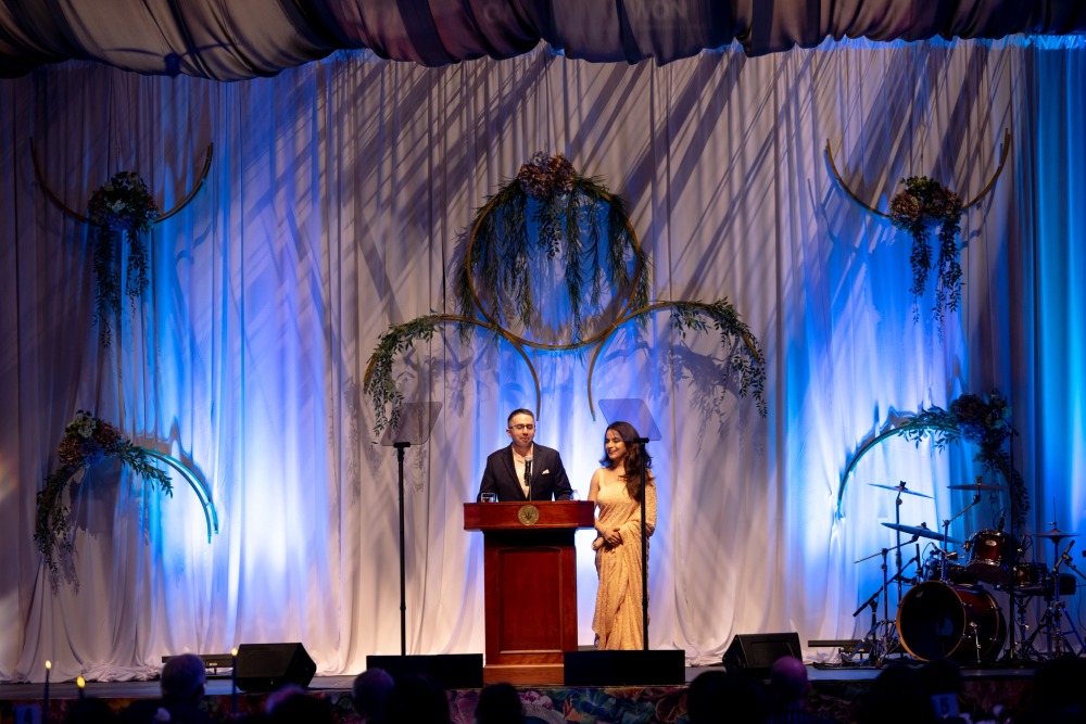 Nandini Puri '14 and her husband, Andrew, address the audience at the 2024 Peace Gala.