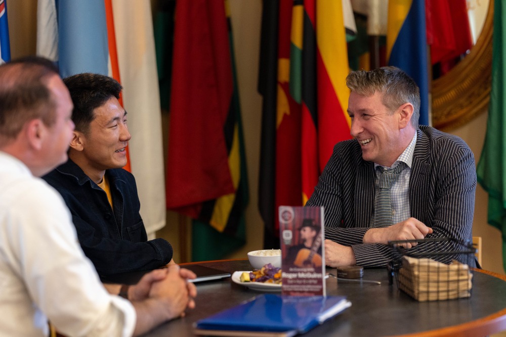 Katsukawa speaks with Dr. Asle Toje, deputy leader of the Norwegian Nobel Committee, during his visit to SUA.