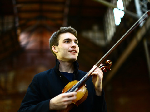 Alexi Kenney holding violin