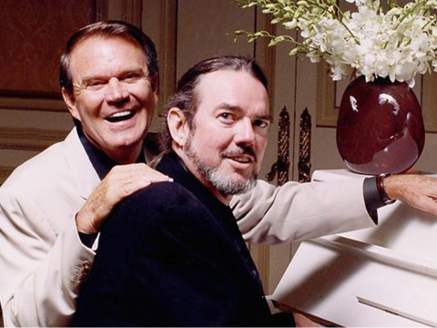 Glen Campbell and Jimmy Webb sitting at piano