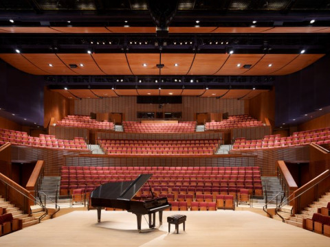 Interior of Concert Hall with piano and bench center stage
