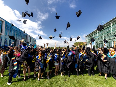 2024 SUA Graduates toss their caps in the air in celebration of commencement