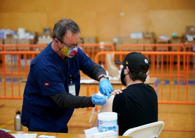 Technician vaccinates man in SUA recreation center