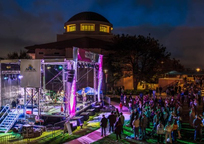 Ozomatli performs on a lit up stage at night on SUA's campus during the 2024 Soka Peace Festival