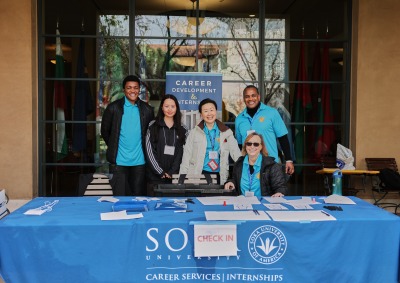 The Career Development and Internships Office team poses for a photo at their table outside the Bistro