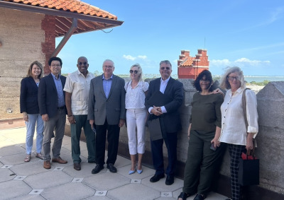 Men and women representing Soka University of America and the Hazel Henderson Center pose for a photo on a rooftop.