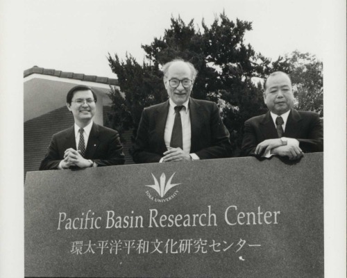 Three men stand behind the PBRC sign to commemorate its opening.