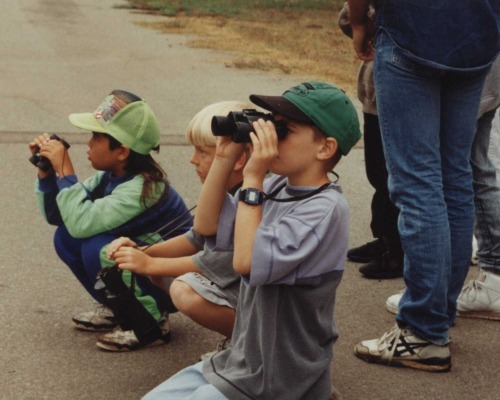 Kids look through binoculars