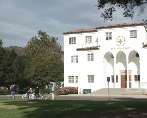 People ride bicycles outside of Minuteman Hall on SUA's Calabasas Campus