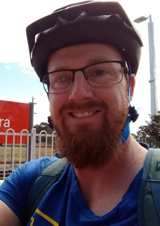 Headshot of Shane Barter wearing a bicycle helmet.